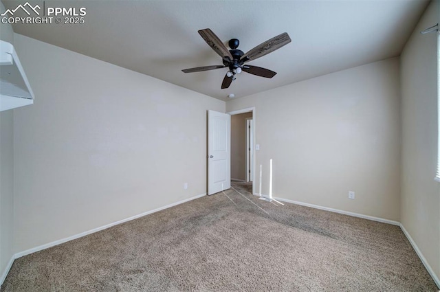 spare room with light colored carpet and ceiling fan