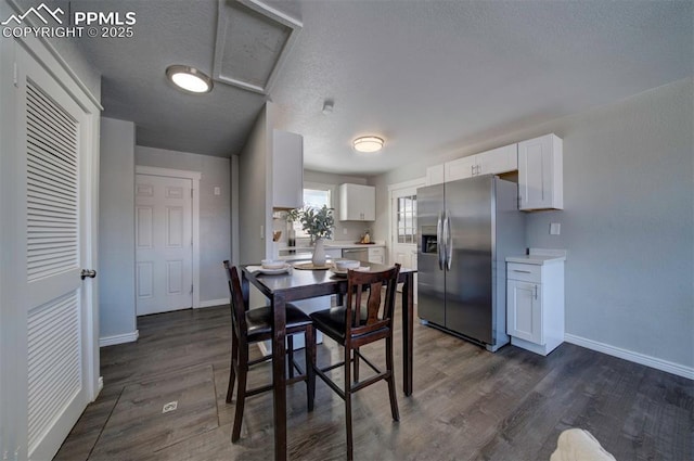 dining room featuring dark hardwood / wood-style floors and a textured ceiling