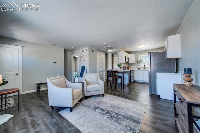 living room with sink and dark hardwood / wood-style floors