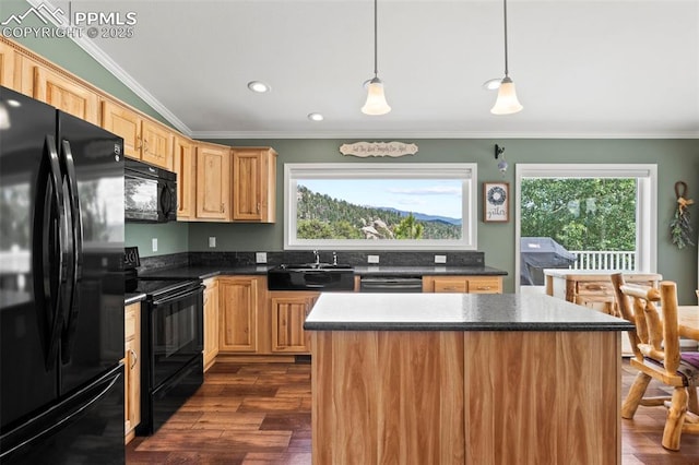 kitchen with sink, hanging light fixtures, a kitchen island, a healthy amount of sunlight, and black appliances