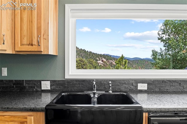 kitchen featuring dishwashing machine, sink, and a mountain view