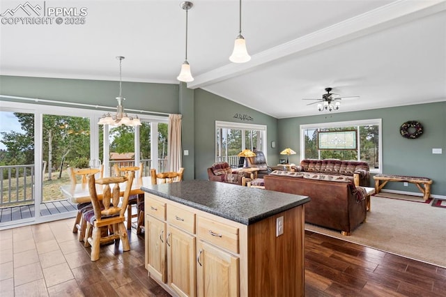 kitchen featuring a healthy amount of sunlight, dark hardwood / wood-style flooring, lofted ceiling with beams, and hanging light fixtures