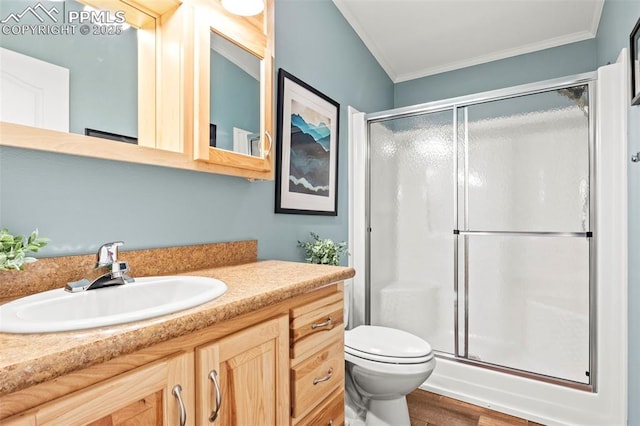 bathroom featuring crown molding, vanity, and a shower with door