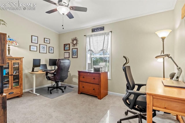 carpeted office space with crown molding and ceiling fan