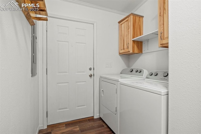 washroom featuring dark hardwood / wood-style flooring, cabinets, ornamental molding, and washer and dryer