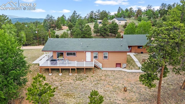 back of house featuring a wooden deck