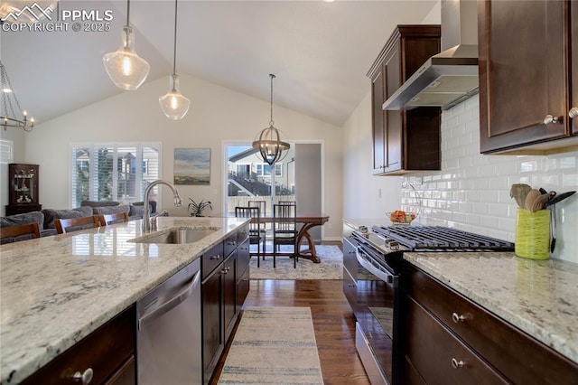 kitchen with a chandelier, a sink, wall chimney range hood, stainless steel dishwasher, and gas stove