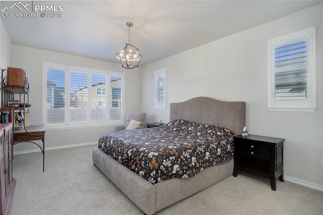 bedroom with carpet floors, an inviting chandelier, and baseboards