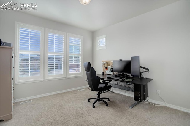 carpeted office featuring visible vents and baseboards