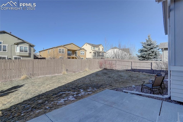 exterior space with a fenced backyard and a residential view