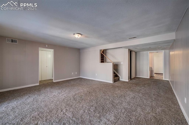 empty room featuring carpet flooring and a textured ceiling