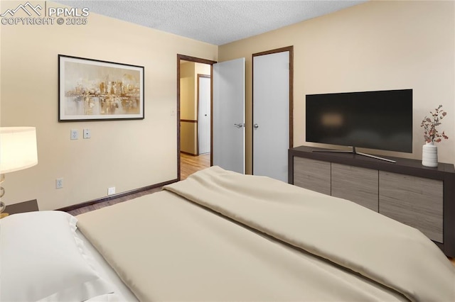 bedroom with a textured ceiling and light hardwood / wood-style flooring