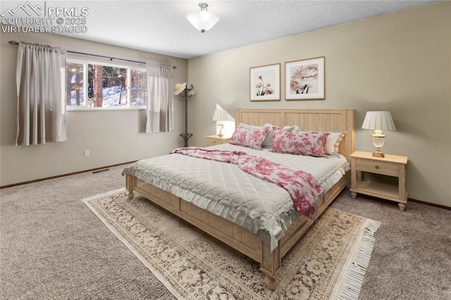 carpeted bedroom with a textured ceiling