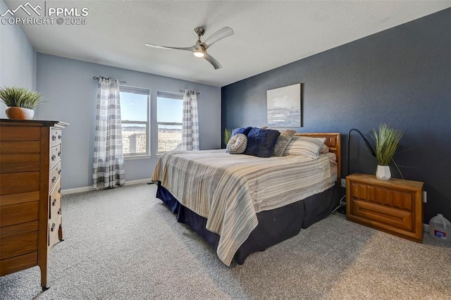 carpeted bedroom featuring a textured ceiling and ceiling fan