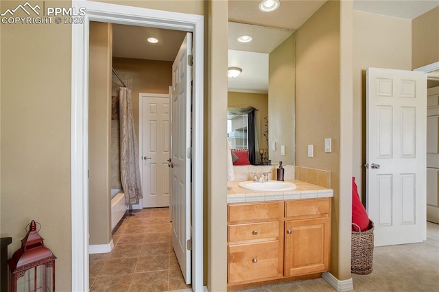 bathroom with tile patterned flooring, vanity, and shower / bath combo