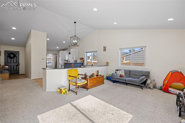 living room with vaulted ceiling, plenty of natural light, and light colored carpet