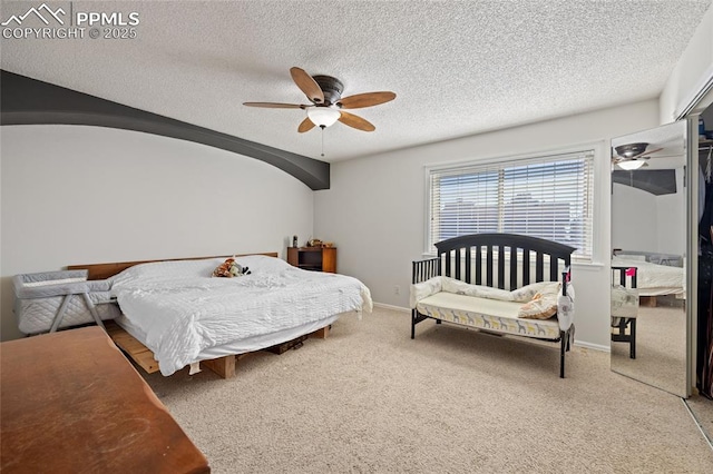 carpeted bedroom featuring ceiling fan, lofted ceiling, and a textured ceiling