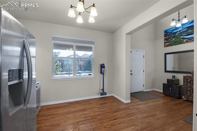 interior space with hardwood / wood-style flooring and a chandelier