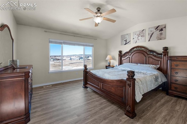 bedroom with ceiling fan, lofted ceiling, and dark hardwood / wood-style flooring