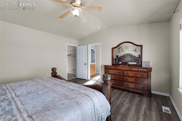 bedroom with lofted ceiling, dark wood-type flooring, connected bathroom, and ceiling fan