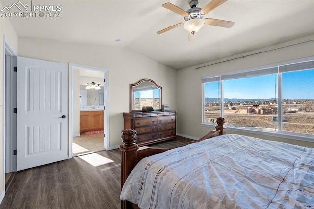 bedroom with hardwood / wood-style flooring, vaulted ceiling, ensuite bathroom, and ceiling fan