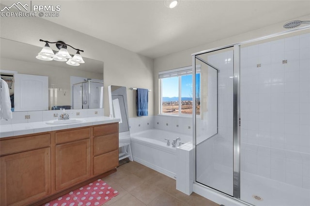 bathroom featuring vanity, tile patterned floors, and separate shower and tub