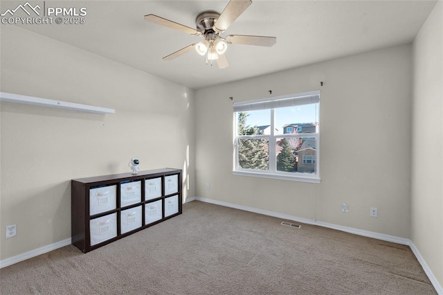 unfurnished room featuring ceiling fan and light carpet