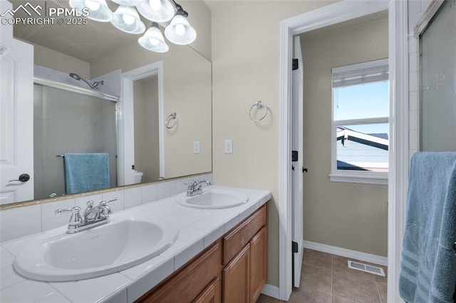 bathroom featuring vanity, toilet, an enclosed shower, and tile patterned flooring