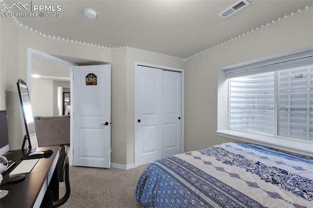 bedroom featuring light colored carpet and a closet