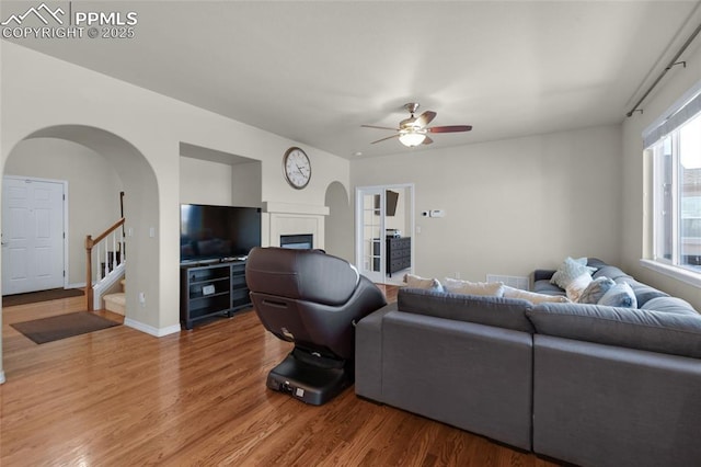 living room featuring ceiling fan and hardwood / wood-style floors