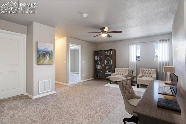office space featuring baseboards, a ceiling fan, carpet flooring, and visible vents