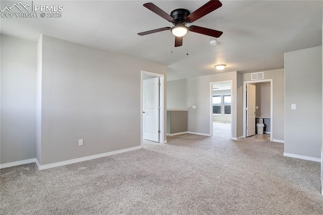 spare room with baseboards, ceiling fan, light carpet, and visible vents