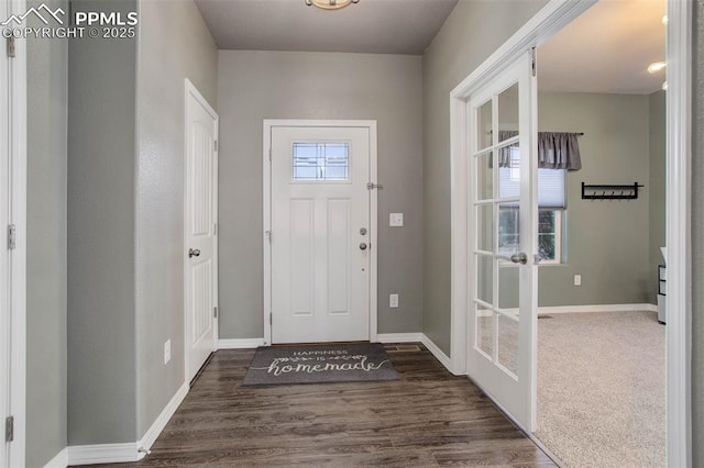 foyer entrance with baseboards and dark wood-style flooring