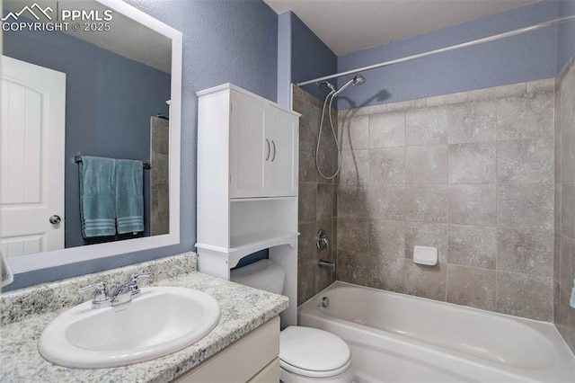 bathroom with vanity, washtub / shower combination, and toilet