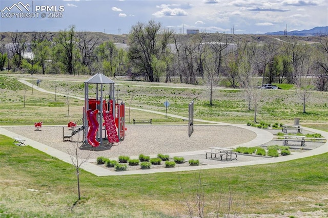 community play area featuring a lawn and a mountain view