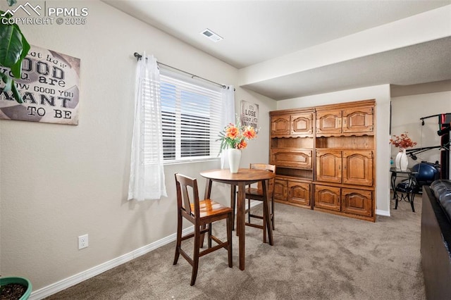 dining room featuring light colored carpet