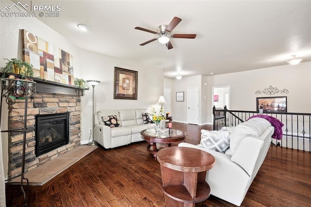 living room with ceiling fan, dark wood-type flooring, and a fireplace