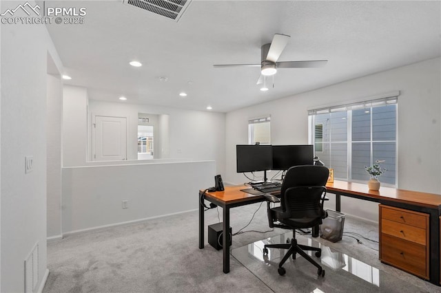 home office featuring light carpet and ceiling fan