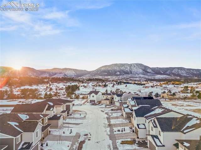 snowy aerial view featuring a mountain view