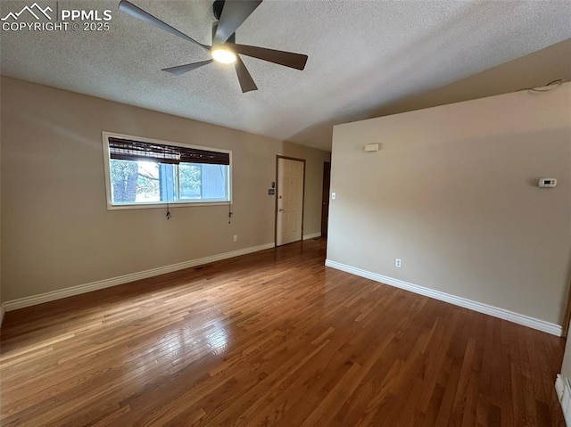 spare room featuring hardwood / wood-style flooring, ceiling fan, and a textured ceiling