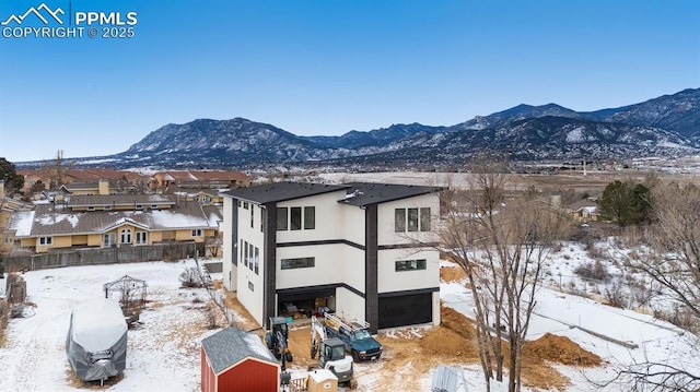 snow covered house with a mountain view