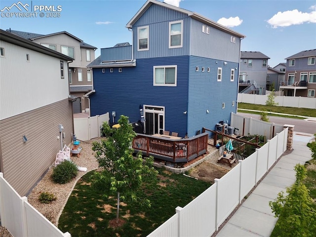 rear view of house featuring a deck