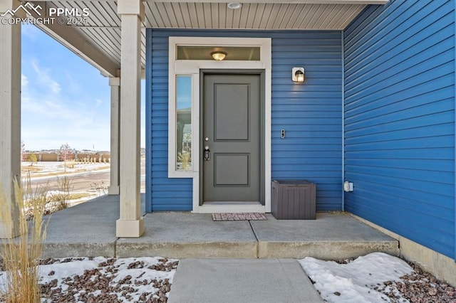 view of snow covered property entrance