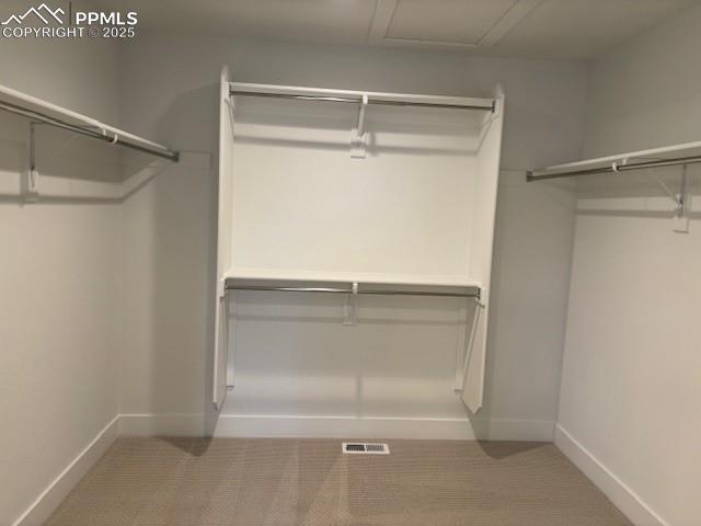 walk in closet with attic access and visible vents