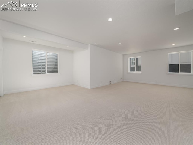 empty room featuring baseboards, recessed lighting, and light colored carpet
