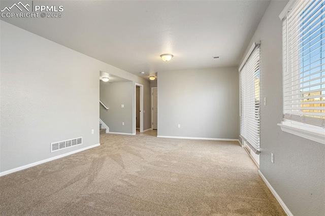 empty room featuring light colored carpet