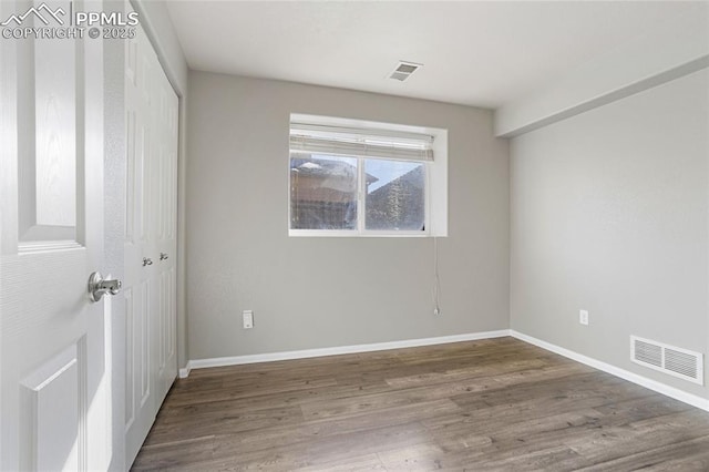 spare room featuring hardwood / wood-style flooring