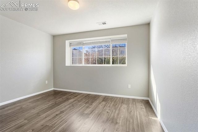 empty room featuring wood-type flooring