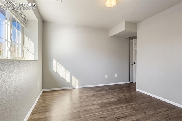 unfurnished room featuring dark hardwood / wood-style flooring