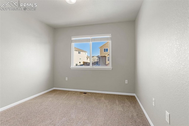 unfurnished room featuring carpet flooring